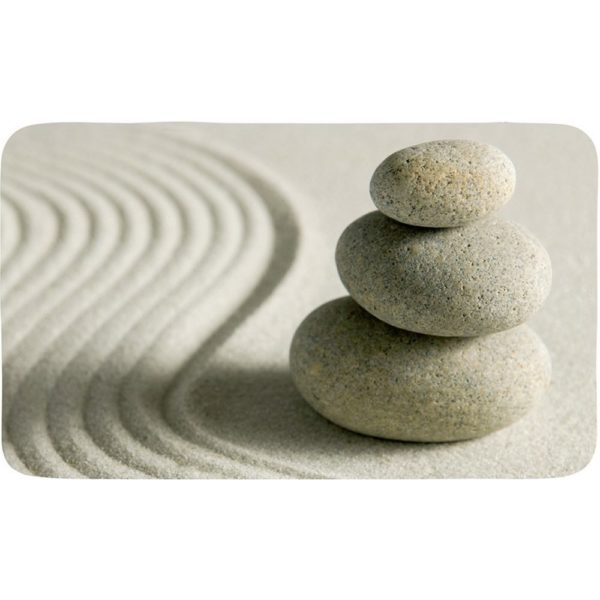 rectangular bath mat with photographic design of a stack of 3 light beige stones stacked on similarly coloured sand, a waved line pattern runs from top to bottom to the left of the stones