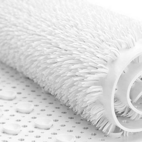 section of a rolled up white bath mat with soft plastic bristle texture on top and suction cups underneath