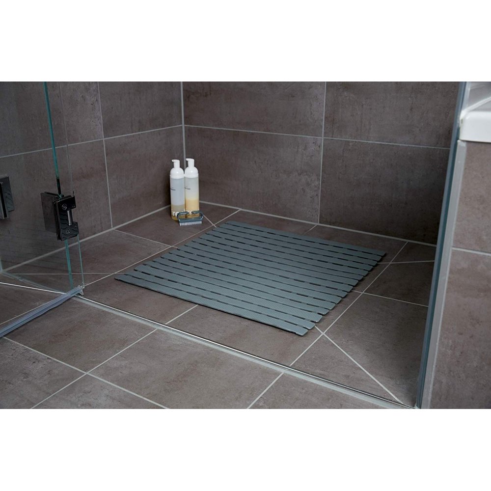 Dark grey plastic, square shower mat in a slatted design in situ in a grey, tiled shower enclosure