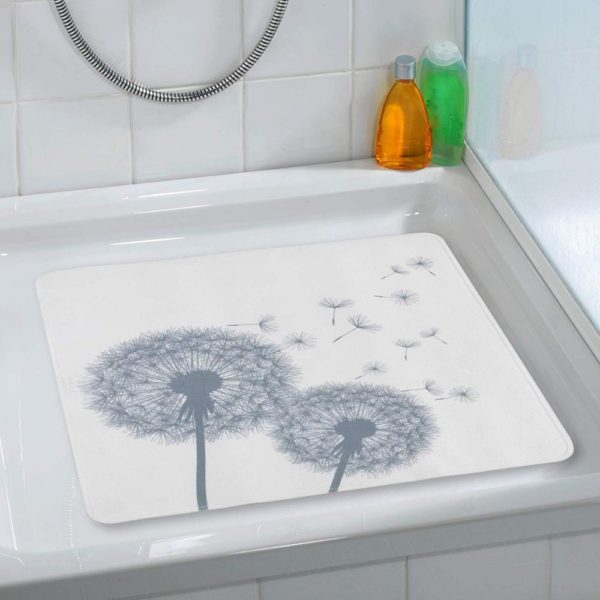 a white, square shower mat with grey silhouettes of two dandelion clocks with a few seeds being scattered in situ photo on a plain white, square shower tray in a white bathroom