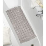 rectangular, plastic bath mat composed of taupe pebble shapes. It is centred in a white bathtub