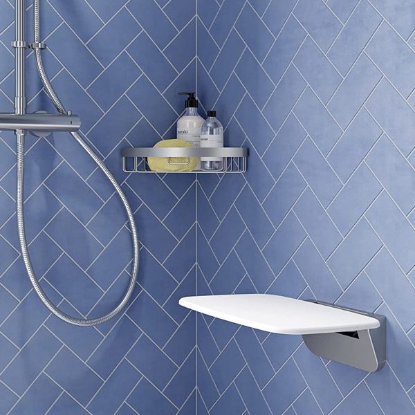square white plastic shower seat with rounded corners on a chrome hinge. it is shown folded down. in a blue tiled shower area