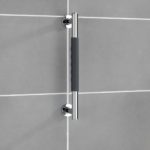 chrome straight hand rail, in the centre is a black, anti grip section.. it is on a grey tiled wall.
