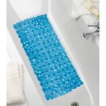 rectangular, plastic bath mat composed of petrol blue pebble shapes. It is centred in a white bathtub