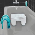 short, square white plastic bath stooll. it has been edited into a bathtub to bemosntrate it's use