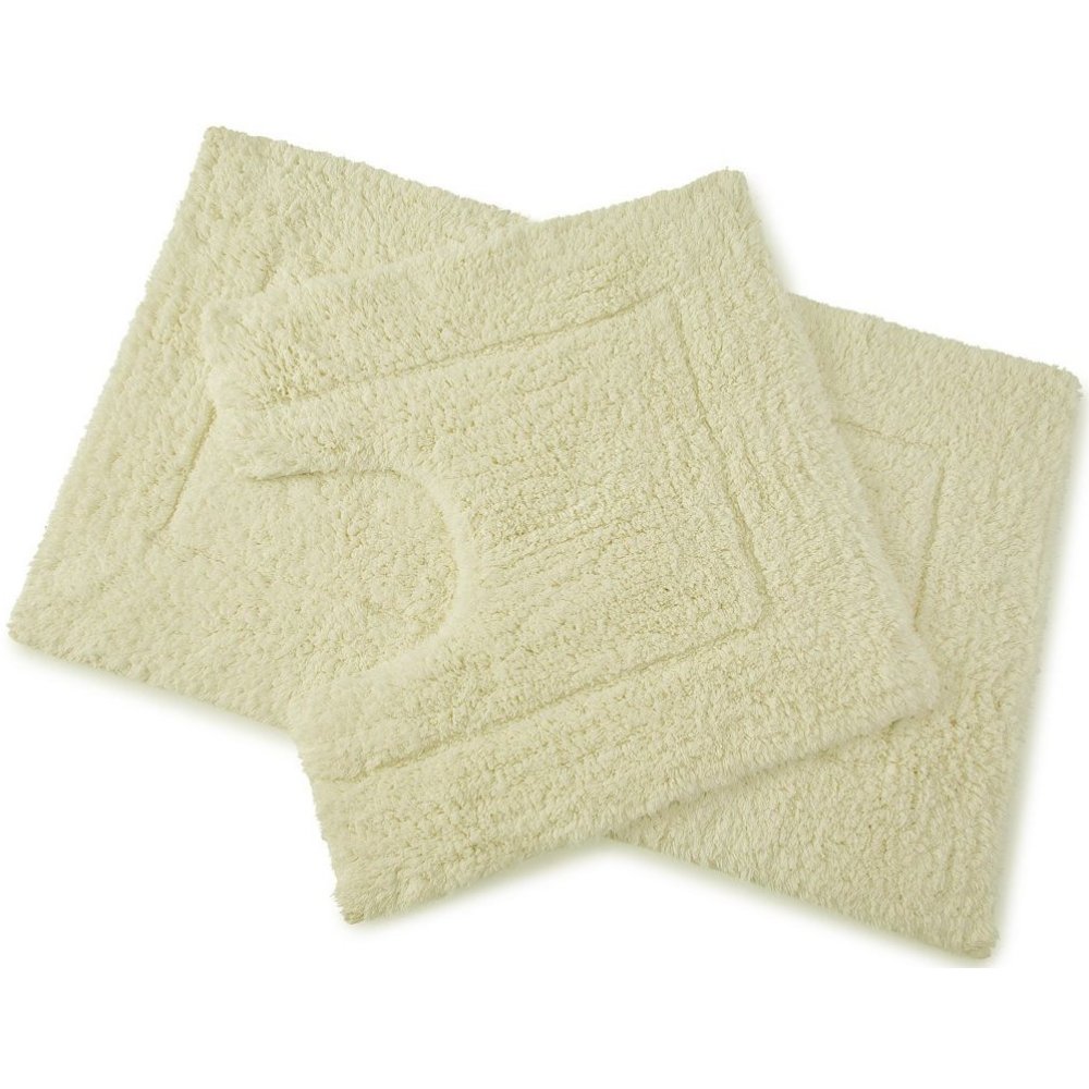 set of 2 cream coloured bath mats laid on top of each other, the bottom one is larger and rectangular whilst the one on top is square with a d shaped section cut out of one side to allow for toilet