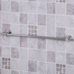 chrome towel rail with round wall brackets on each end it is on a grey tiled background