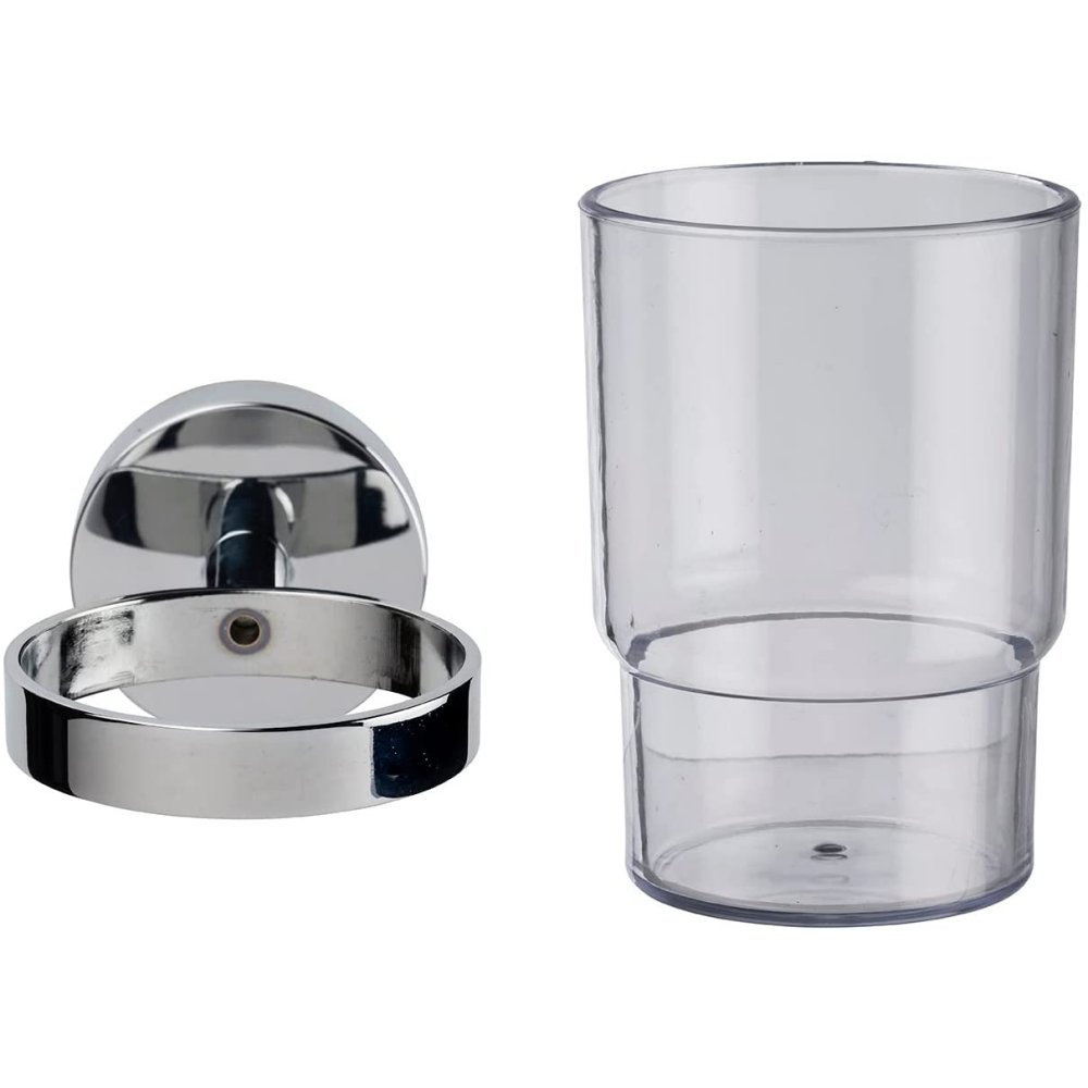 glass tumbler placed next to chrome holder