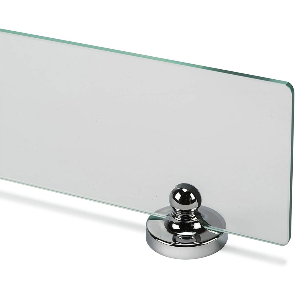 one end of a rectangular glass shelf and a round chrome wall bracket