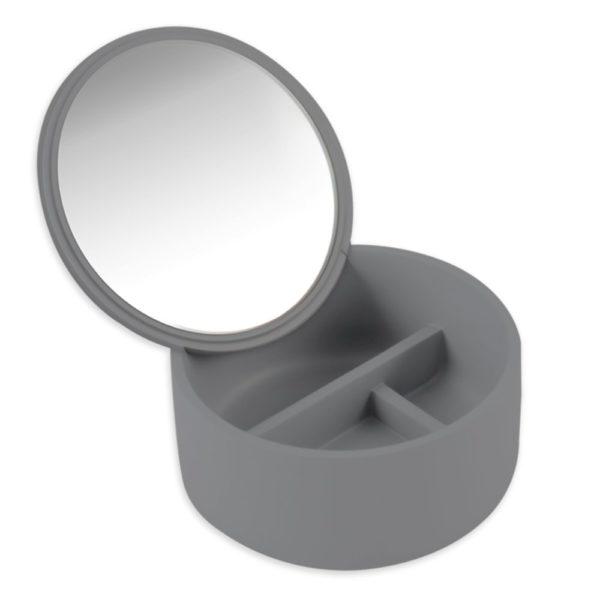 grey circular polyresin box with three compartments in two rows. one in the top row and the bottom row consists of 2 equal sized comaprtments. the insde of the lid is mostly taken up by a circular mirror.