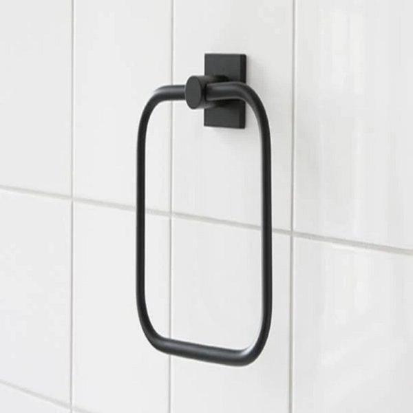black rounded square shaped towel ring with square wall mount on a white tiled wall