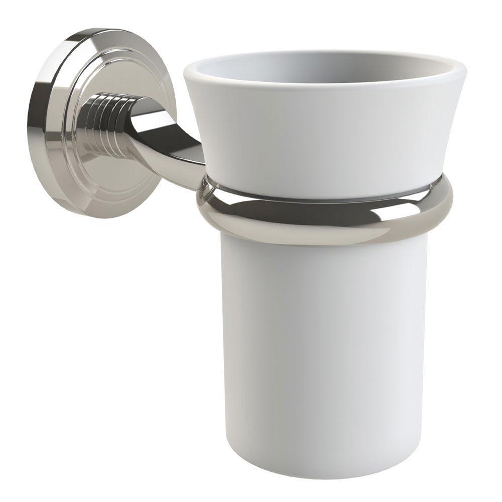 Nickel tumbler holder with a circular wall plate with an indented circular pattern holding a white ceramic tumbler from near the the top